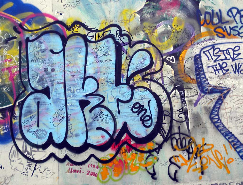 Graffiti tag: light blue letters with dark blue outlines